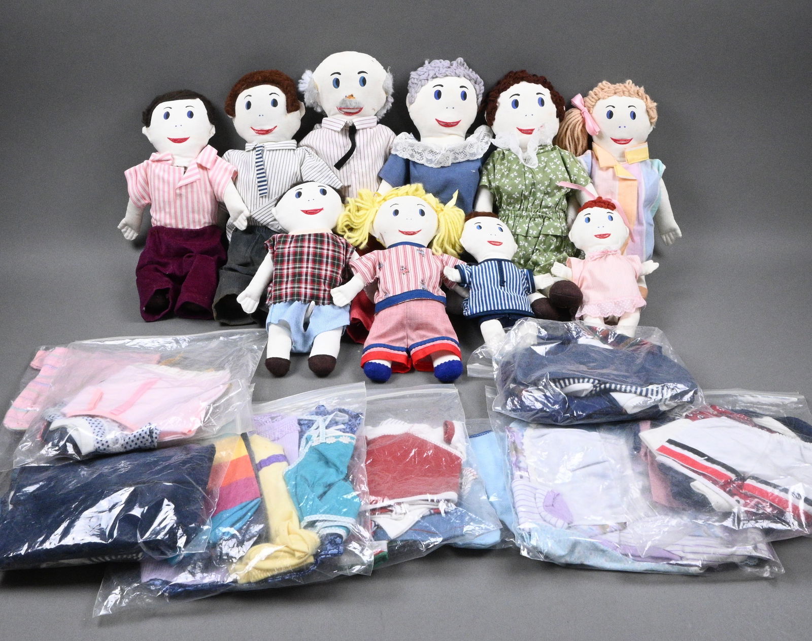 Ten Anatomically Correct Cloth Dolls: Ten Anatomically Correct Cloth Dolls. Hand-stitched clothing, yarn. Comes with a lot of spare clothing. All exposed dolls in pictures are of age, although the younger dolls are detailed as well. Excel