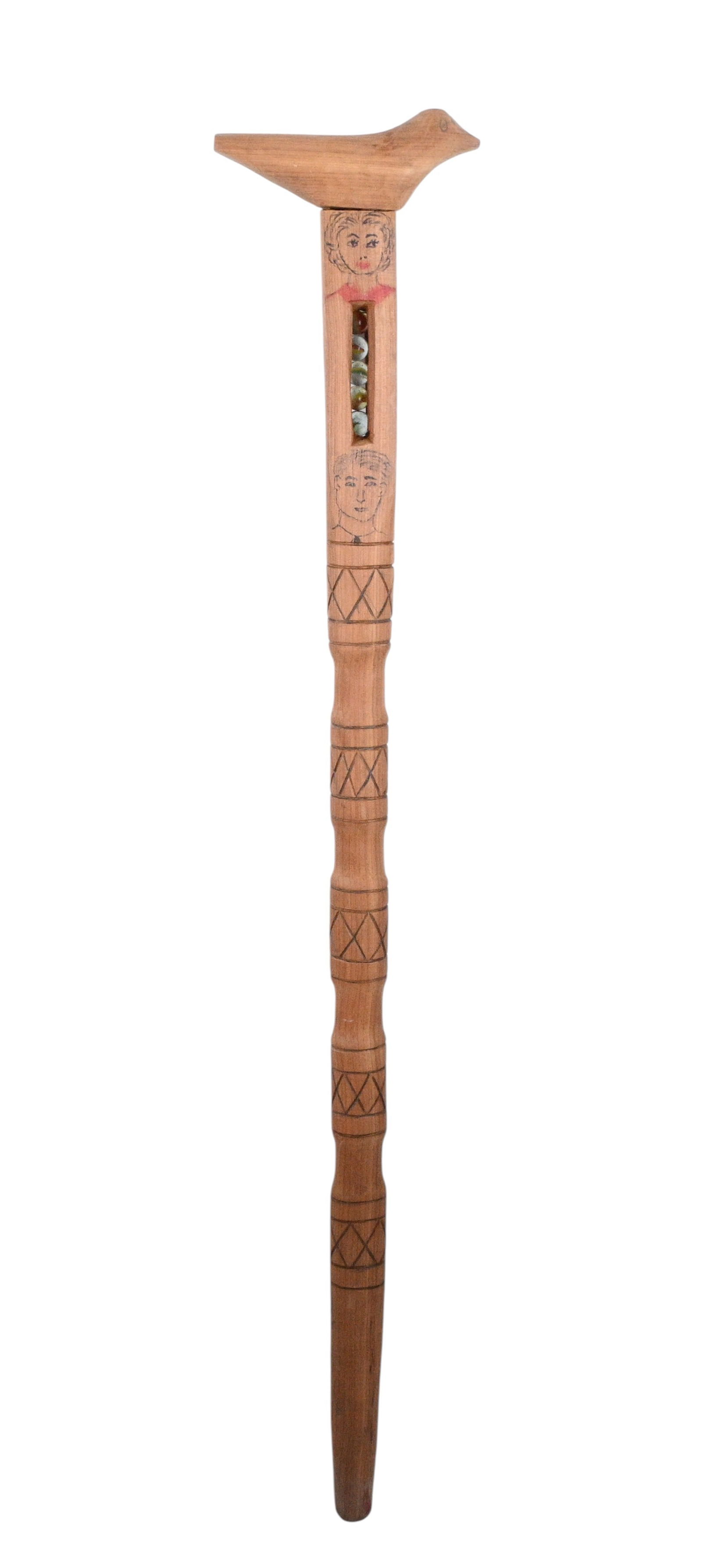 Baker Riddle. Carved Whimsy Cane: Baker Riddle. Carved Whimsy Cane. Not Signed. Hand carved wooden cane topped with a carved bird handle, the shaft decorated with incised geometric bands and two inked portrait faces. A narrow vertical