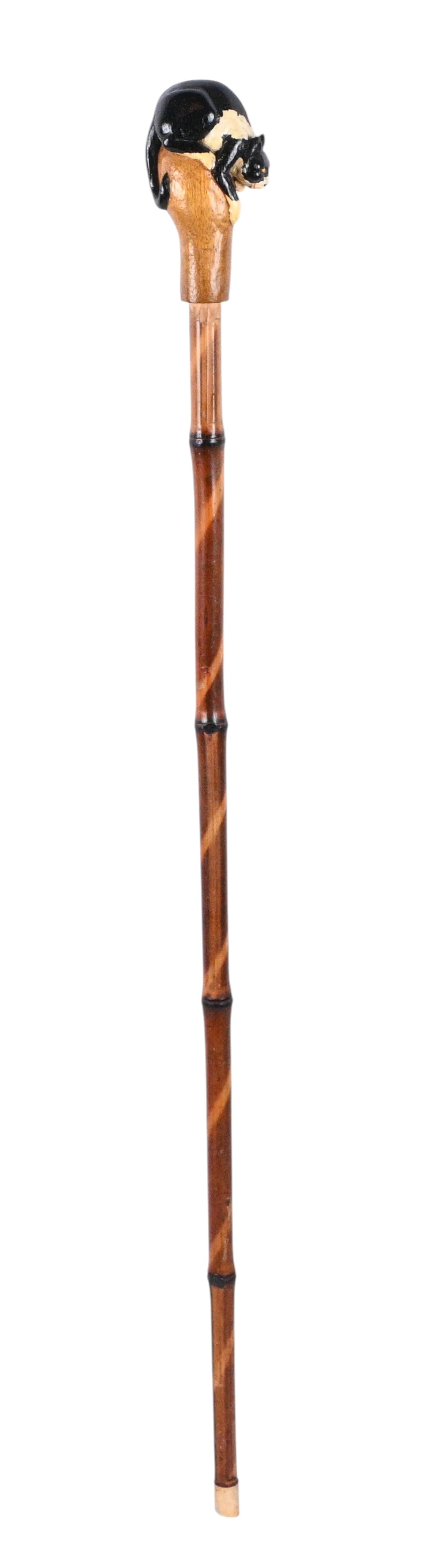 Cat & Mouse Wood Carved Cane: Cat & Mouse Wood Carved Cane. Hand carved wooden folk art cane featuring a black and white cat perched on top looking for the mouse who is cleverly looking out from a hidden hole just below the cat.