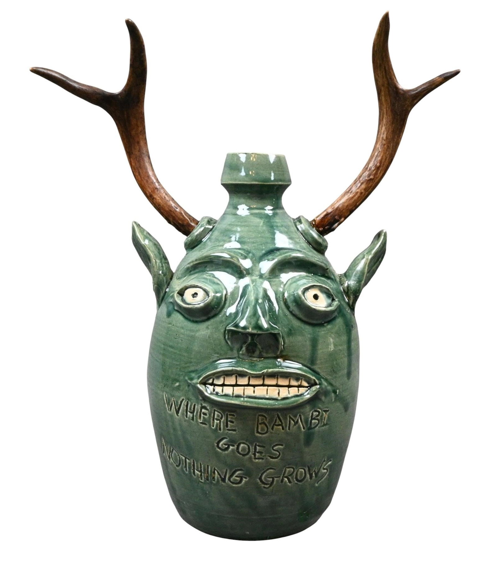 Randy Tobias. Deer Antler Face Jug: Randy Tobias. Deer Antler Face Jug. 2026. Signed and Titled. Where Bambi Goes Nothing Grows. Mint condition. Size: 17.25" H. Provenance: Direct from Randy Tobias. Let's help support living artists.