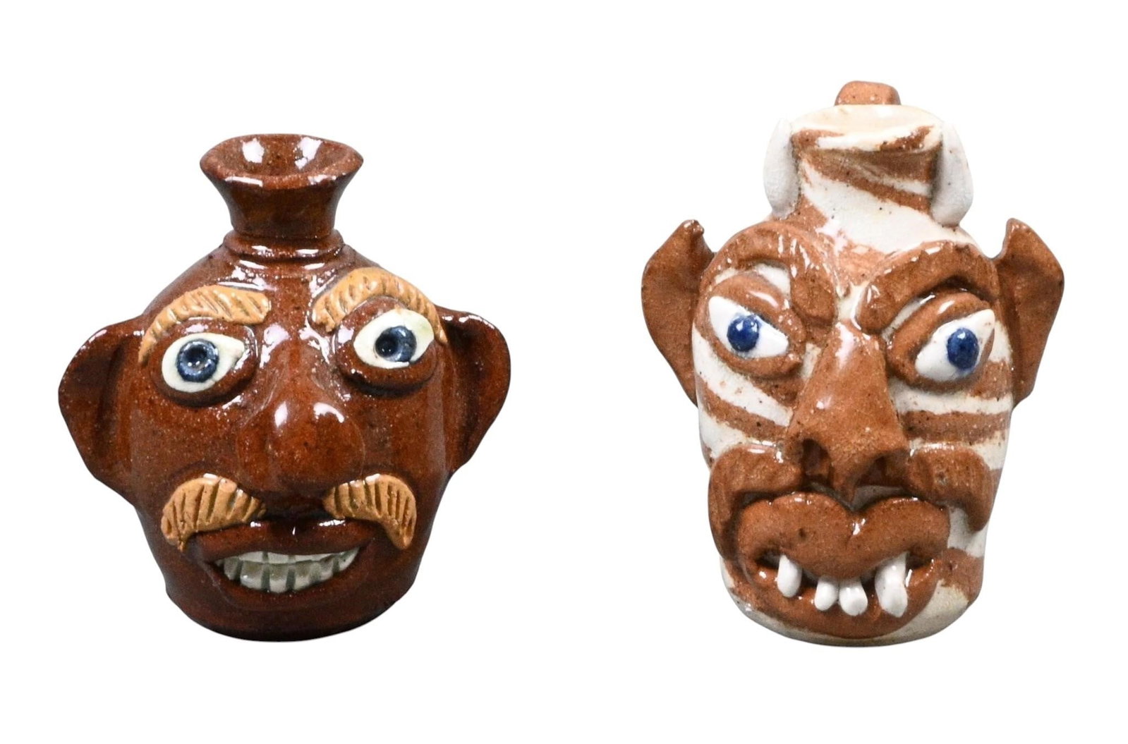 Albert Hodge. Two Mini Face Jugs: Albert Hodge. (b. 1941) Two Mini Face Jugs. Signed. Mint condition. Size: Largest is 2.75" H. Provenance: Collection of Micki Beth Stiller. Montgomery, AL. Est. $100 - $200. Ship: In-House Shipping