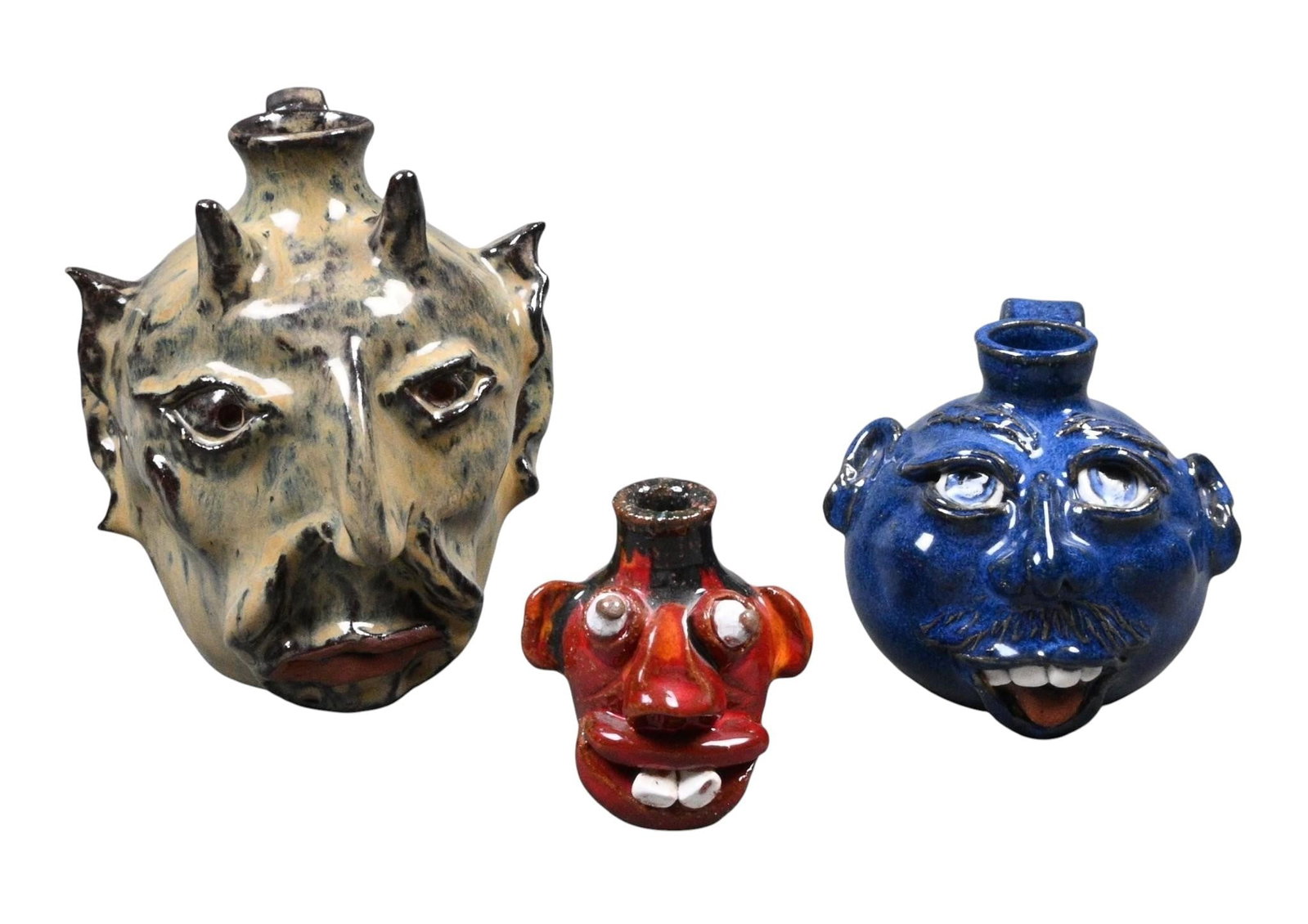 3 Face Jugs: 3 Face Jugs. Signed. The largest is done by Mike Calhoun. The blue jug is by JS Pottery. The smallest is done by Timmy Lowery. Mint condition. Size: Largest is 5.5" H. Provenance: Collection of Micki
