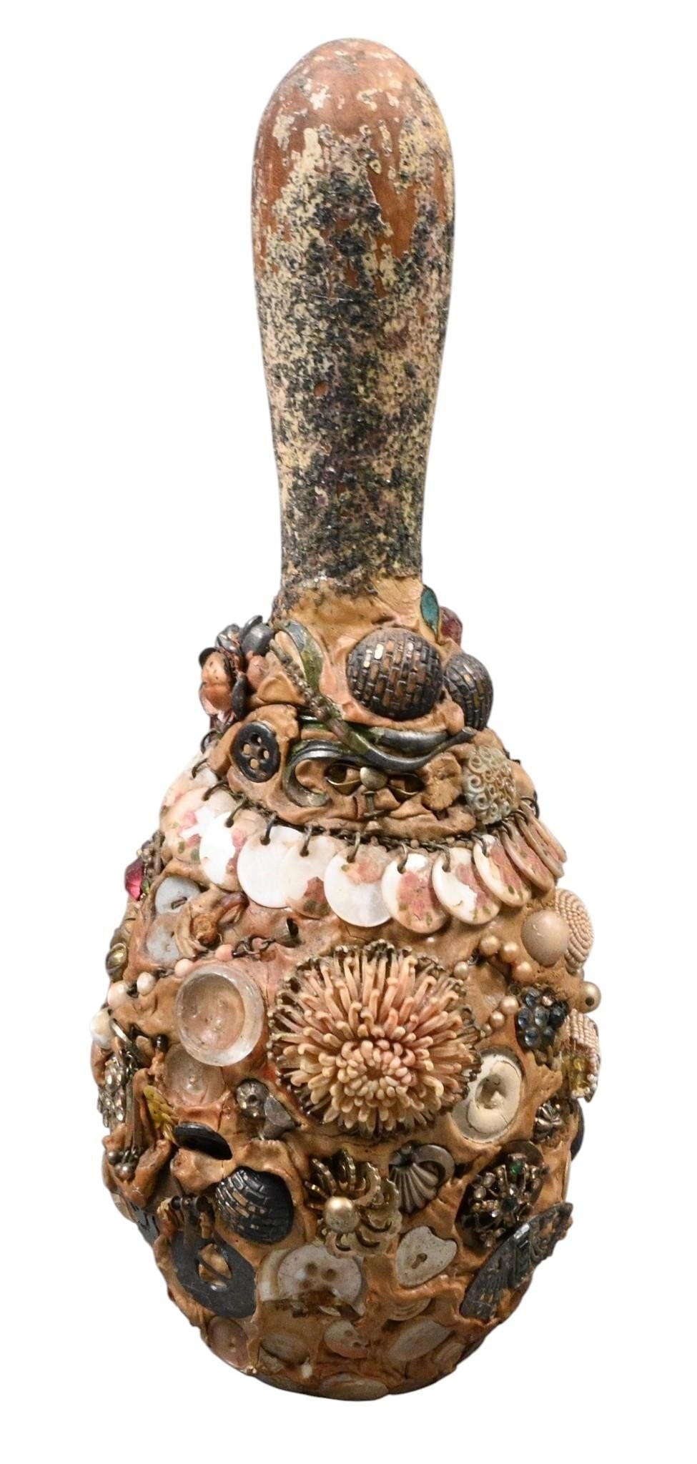 Memory Antique Bowling Pin: Memory Antique Bowling Pin. Antique bowling pin covered in jewelry and found objects. Good aged condition. Size: 13" H x 5" W. Provenance: From the collection of Scott Peppers. Est. $50 - $200. Ship: