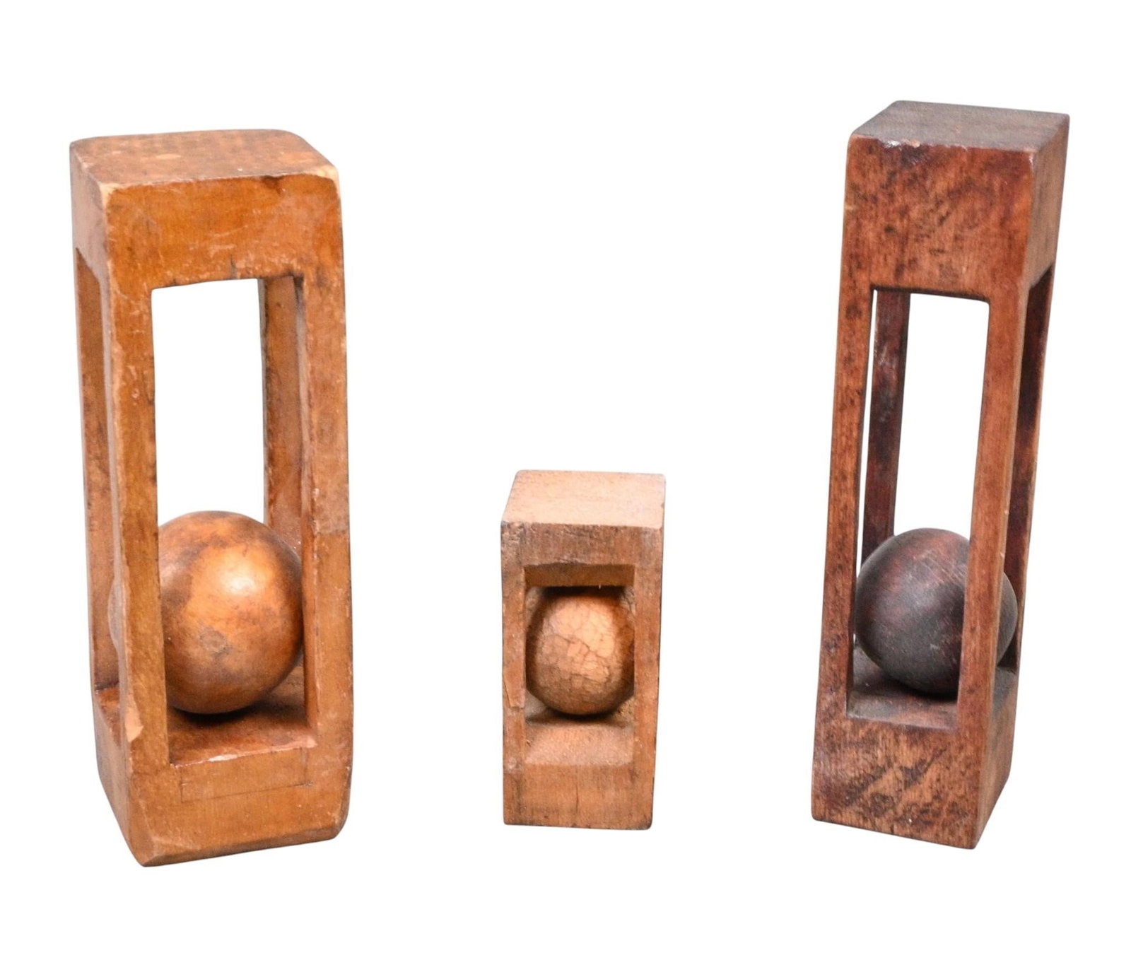 Group of Three Ball in Cage Whimsies: Group of Three Ball in Cage Whimsies. Group of carved wooden folk art whimsies, each demonstrating the woodworker's skill by enclosing a freely moving carved sphere within an open rectangular frame.