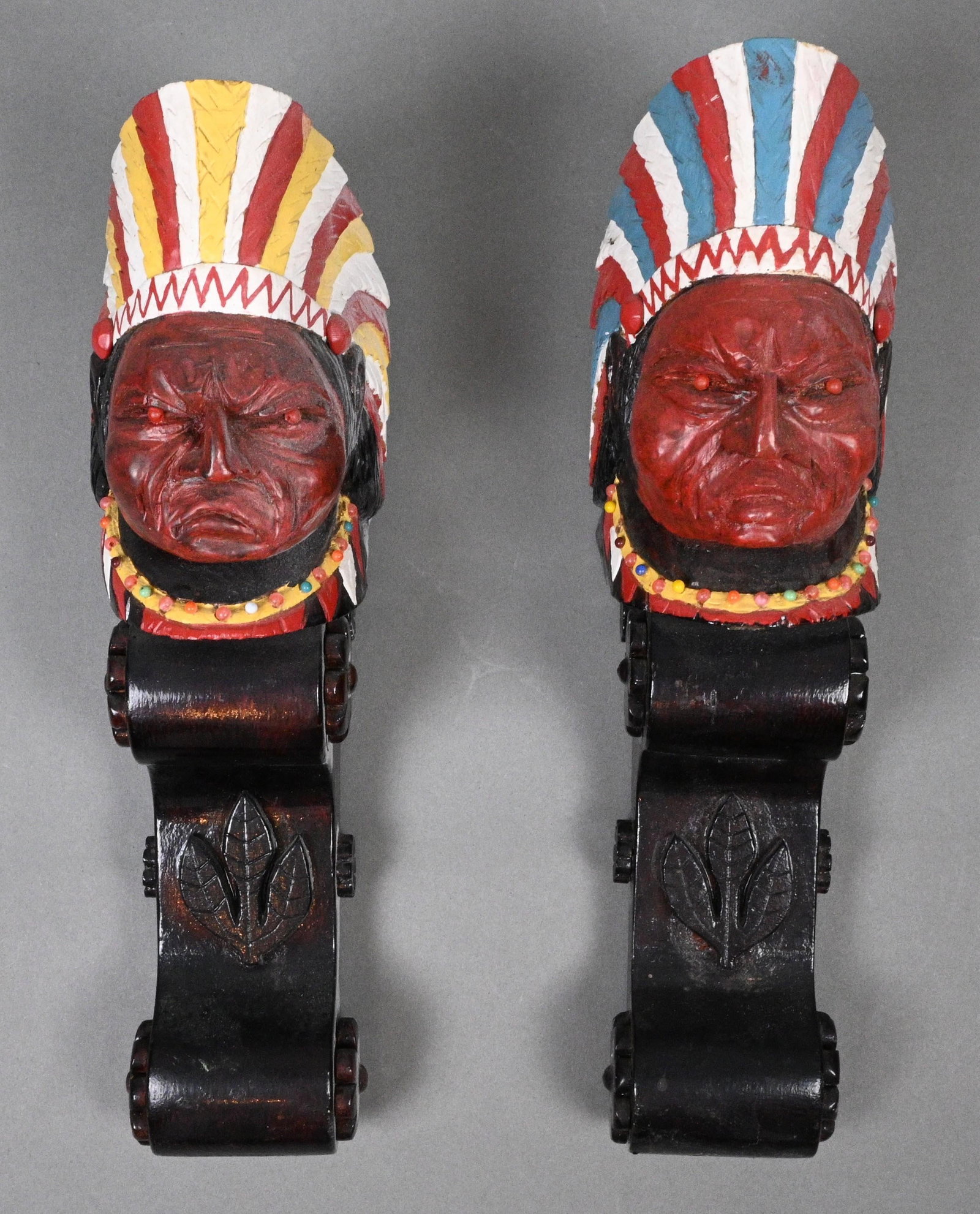W. Fagin. Pair of Native American Figural Wall Plaques: W. Fagin. Pair of Native American Figural Wall Plaques. 1974. Signed and Dated. Matched pair of hand carved and hand painted wooden wall plaques depicting Native American busts wearing colorful feathe