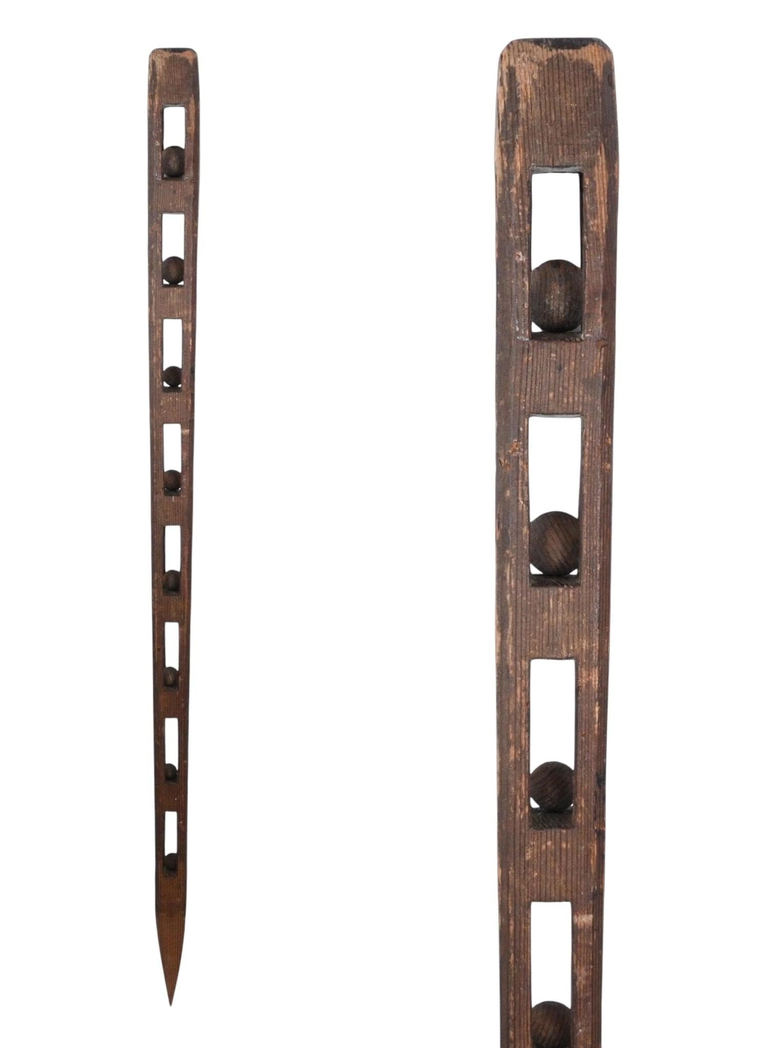 Large Whimsy Cane with Eight Enclosed Balls: Large Whimsy Cane with Eight Enclosed Balls. Carved wood. Hand carved whimsy cane with eight wooden enclosed balls with a pointed bottom. Good condition with natural surface wear. Size: 38.75" H x 2"