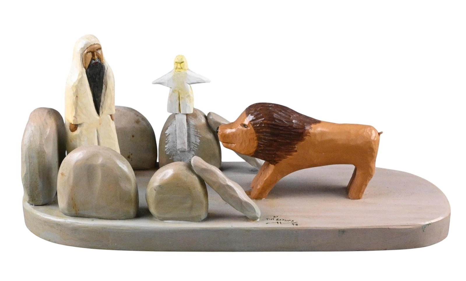Tim Ratliff. Daniel in the Lion's Den Sculpture: Tim Ratliff. Daniel in the Lion's Den Sculpture. 1998. Signed, Dated, and Titled. Carved and painted wood assemblage. Painted carved wood folk art sculpture by Kentucky artist Tim Ratliff, depicting