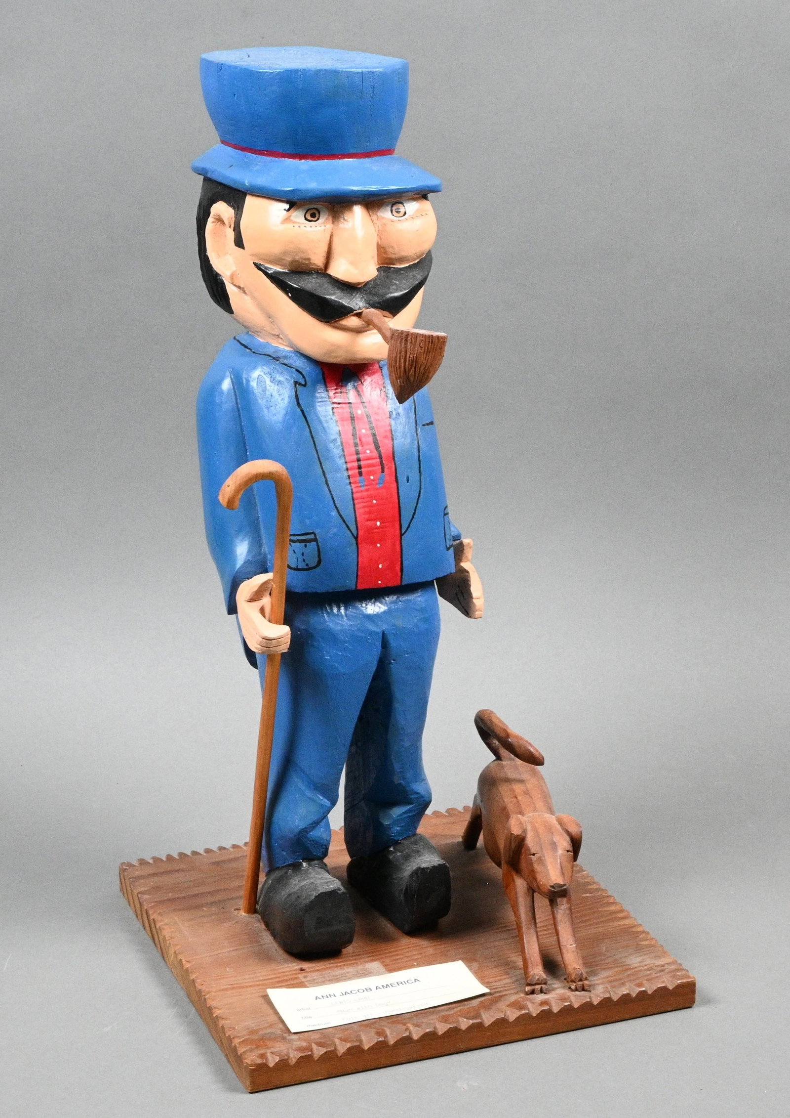 Lewis Lamb. Man with Dog: Lewis Lamb. Man with Dog. Signed. Carved and painted wood. Sculpture depicting a man in a blue suit and a red shirt with a dog. Good condition. Appears to be a repair to the dog's tail and minor