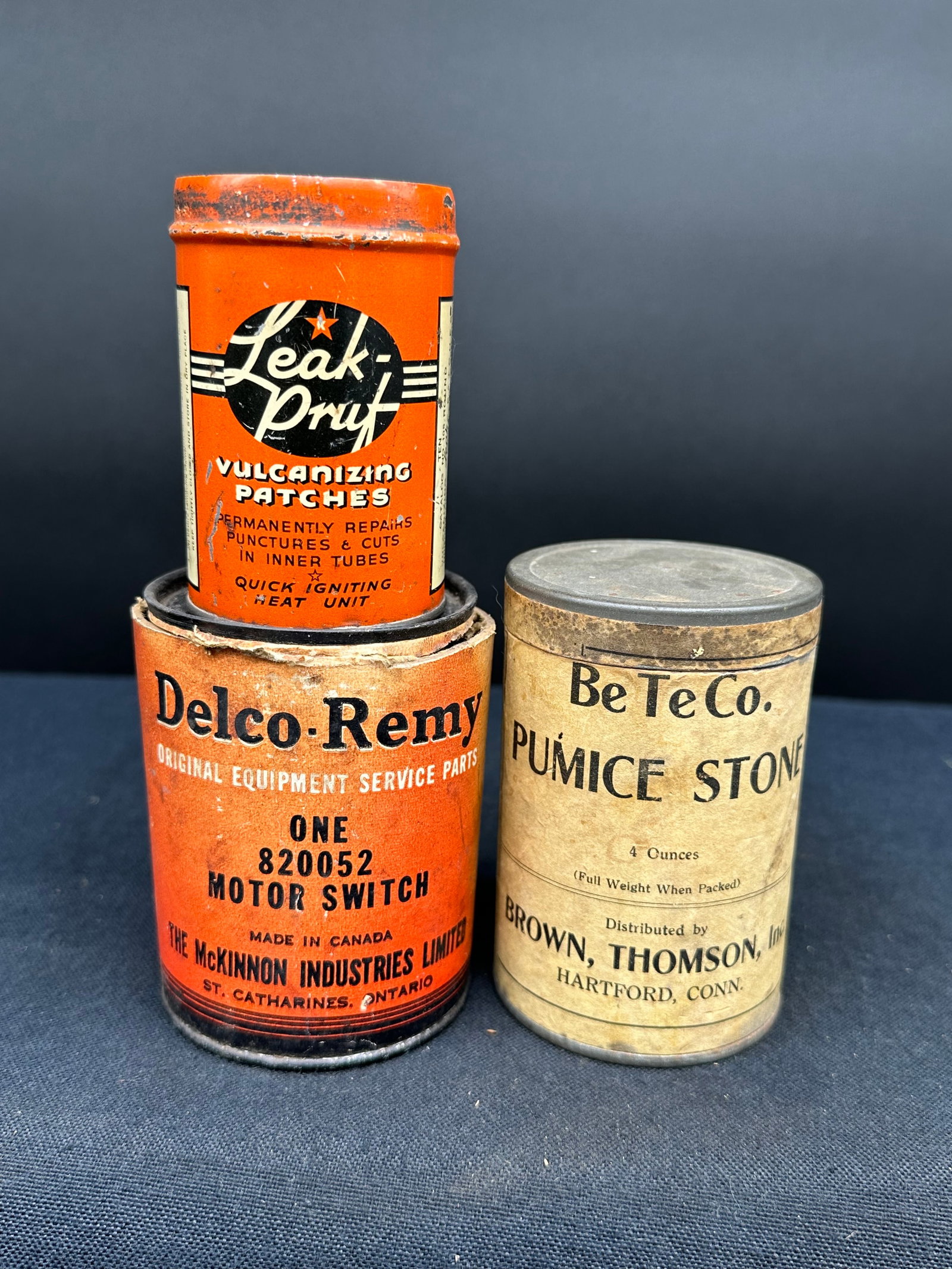 LOT OF 3 AUTOMOTIVE ADVERTISING CANS: Consists of two Delco cans and one leak pruf patch kit.