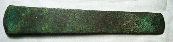 Egypt, Pre-Dynastic Period, COPPER ADZE: Egypt, Pre-Dynastic Period, c. 3100-3000 BC. A nice copper adze blade with sharpened end and nice red. Brown and green patination with some adhering resins. L: 7 3/8". See Petrie, Tools and Weapons, p