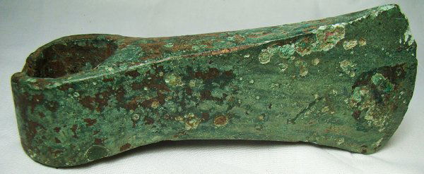 Roman Egypt, c.1st century AD. A bronze socketed a: Roman Egypt, c.1st century AD. A bronze socketed axe-head. Intact and substantial with an attractive olive green patina. L: 5 ¾". See Petrie, Tools and Weapons, pl. XIII, 31-32. Ex Leighton Wilkie co