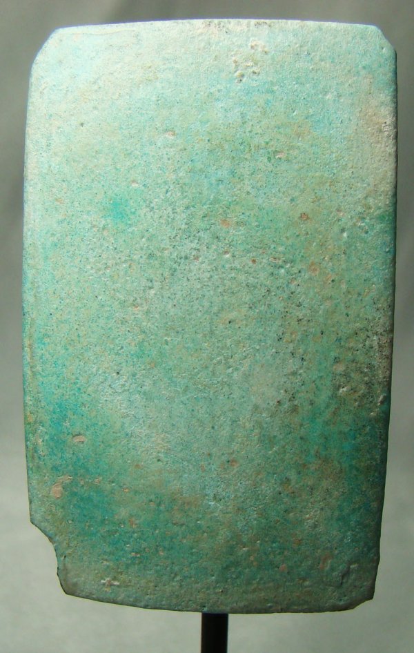 Egypt, Old Kingdom, a rare blue faience tile: Egypt, Old Kingdom, 4th-8th Dynasties, 2575-2150BC. A choice pale turquoise color faience wall tile of rectangular shape. Back side with attachment loop. Custom stand. Small chip to one corner. Rare!