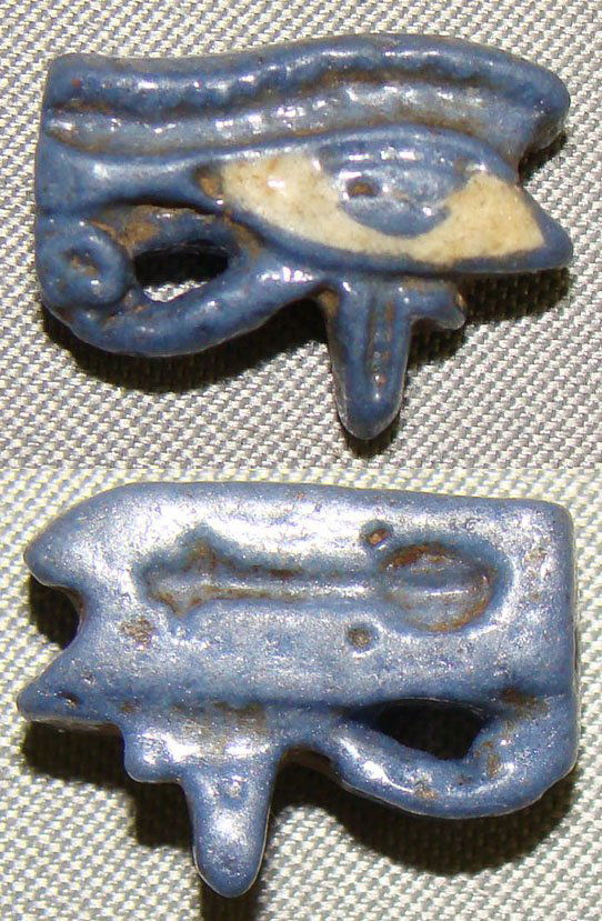Egypt, Late Period, a mini masterpiece "eye": Egypt, Late Period, 20th-30th Dynasties, 715-332BC., a miniature deep blue and white faience wadjet eye or "Eye of Horus" with "nefer" intaglio on base. Ex Dr Albert Potts collection. Ex Dr. Herbert A