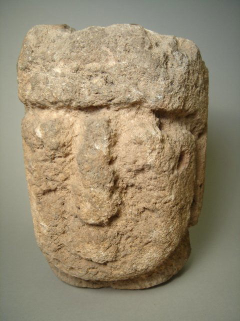 Egypt, Late Period(?), an interesting stone head: Egypt, Late Period(?), an extremely weathered dark creme colored sandstone head. Porous heads still with eyes, nose and mouth recognizable. An interesting study piece as well as a piece in need of fur
