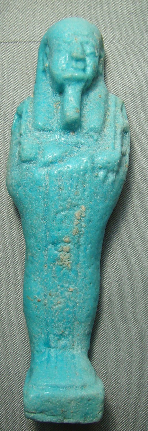 Egypt, Late Period, a choice pale blue ushabti: Egypt, Late Period, 20th-30th Dynasties, 715-332BC., a very nice and attractive pale blue faience ushabti with single vertical row on incised hieroglyphics on the front below the crossed arms of Osiri