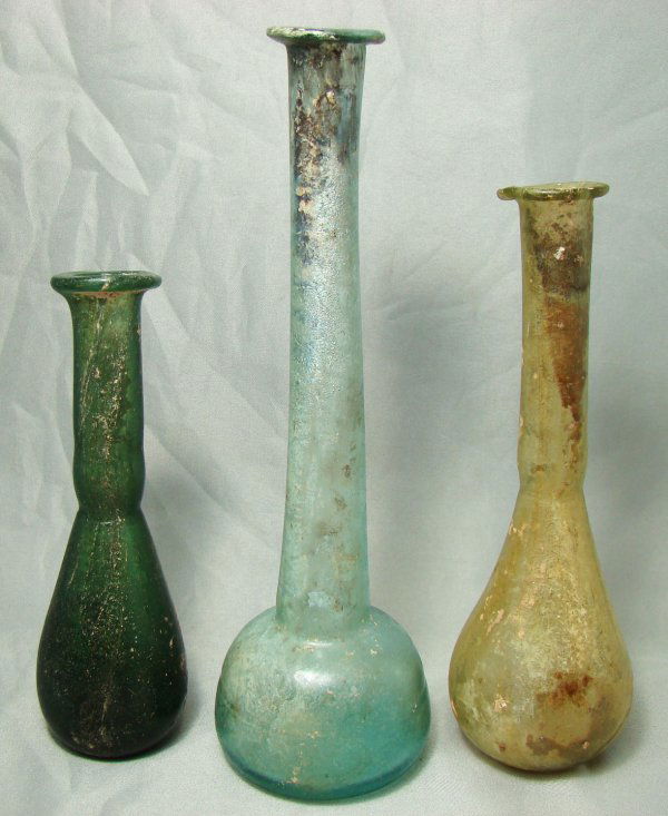 Roman Glass, c.100AD-300AD, a lot of 3 glass vase.: Roman Glass, c.100AD-300AD, a lot of 3 glass vase. Two are "tear vials", the tallest of "candlestick" shape. One yellow-green, one dark and one light green. All are nice and choice. H: 4.25", 5" and 6