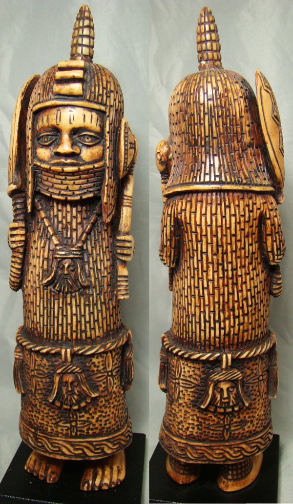Africa, Benin Style African Warrior in ivory : Africa, Benin Style African Warrior, 1900's, an expertly carved ivory of a standing warrior. He stands wearing his full battle armor and single spiked helmet and holds a weapons upwards with each hand