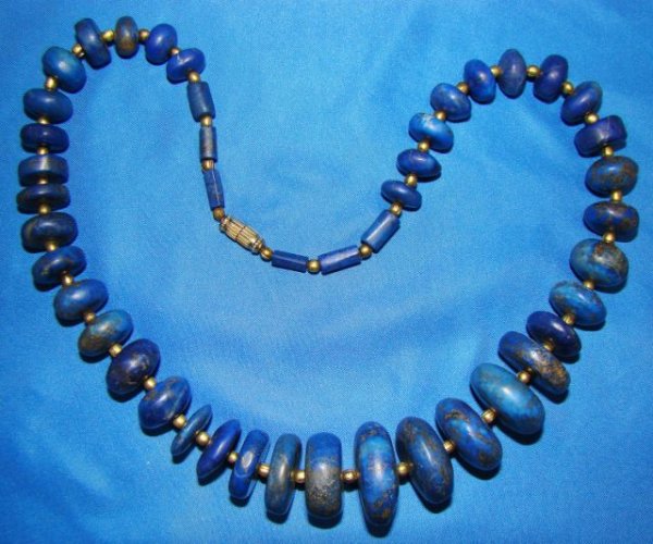 Near Eastern, lapis lazuli and gold bead necklace: Near Eastern, a fantastic ancient lapis lazuli and gold bead necklace. Lapis beads are of varying size and shape. All beads are circular and of compressed flattened shape. All are interspersed with sm