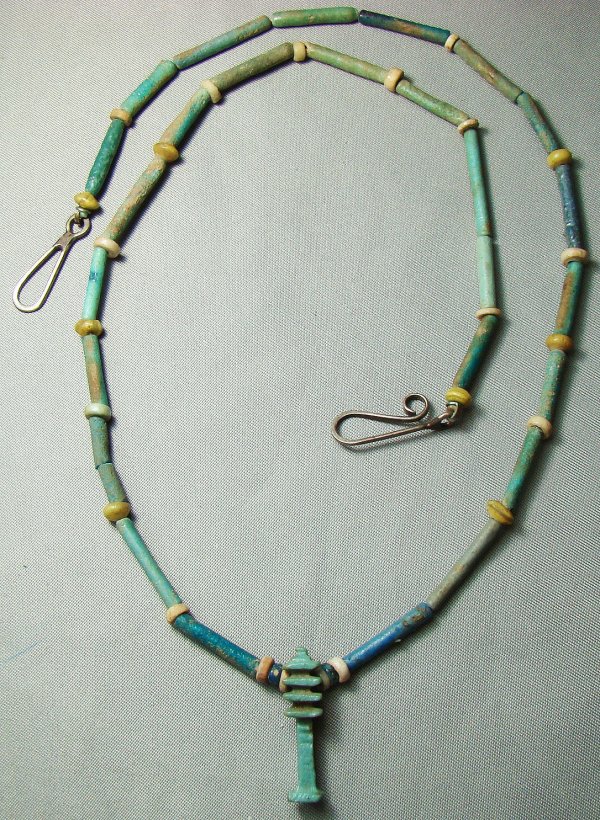 Egypt, Late Period, necklace of tubular beads: Egypt, Late Period, 20th-30th Dynasties, 715-332BC., a mostly pale green necklace consisting of tubular beads with small yellow glass spacer beads. A perfect "pillar" amulet in similar faience as pend