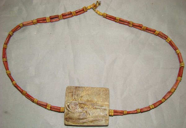 Egypt, faience "Eye of Horus" plaque necklace: Egypt, Late Period, 20th-30th Dynasties, 715-332BC., a wearable beaded necklace with faience "Eye of Horus" plaque. Pale orange tubular beads with smaller double yellow spacers. Plaque is incised on s