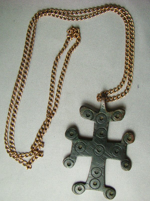 Byzantine, bronze cross as pendant for a necklace: Byzantine, c. 1000AD., a lovely bronze cross as pendant for a necklace. Cross is adorned on both sides with stamped circular designs as are the corners of the cross. S: .25" x 1.5". Old Florida Collec