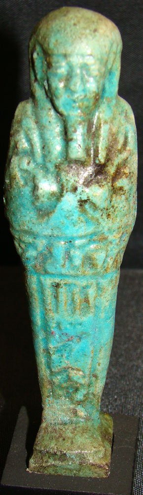Egypt, Late Period, blue glazed faience ushabti: Egypt, Late Period, 26th - 30th Dynasty, 664 - 343 BC. a very nice mottled green-blue glazed faience ushabti with "T" incising of hieroglyphs. Choice condition and mounted on stand. H: 4 1/8". San Fer