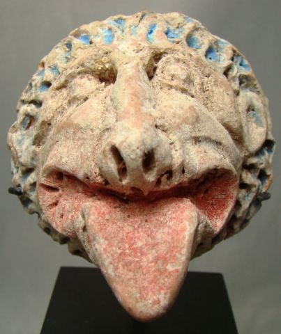 Hellenistic, circular terracotta lion head plaque: Hellenistic, c. 300BC., c. 300BC. A 3 dimensional circular terracotta lion head plaque or appliqué done as a decorative piece. Powerful modeling with mouth agape and tongue extended. With great origi