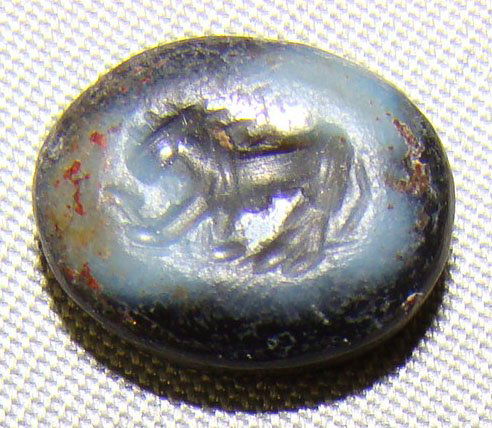 Rome, agate ring stone intaglio with "lion": Rome, c. 350-450 AD., a small agate ring stone intaglio with engraving of a standing lion with full mane small prey held under his front feet. S: 10mm x 8mm. Choice. This would make a fine inset for e