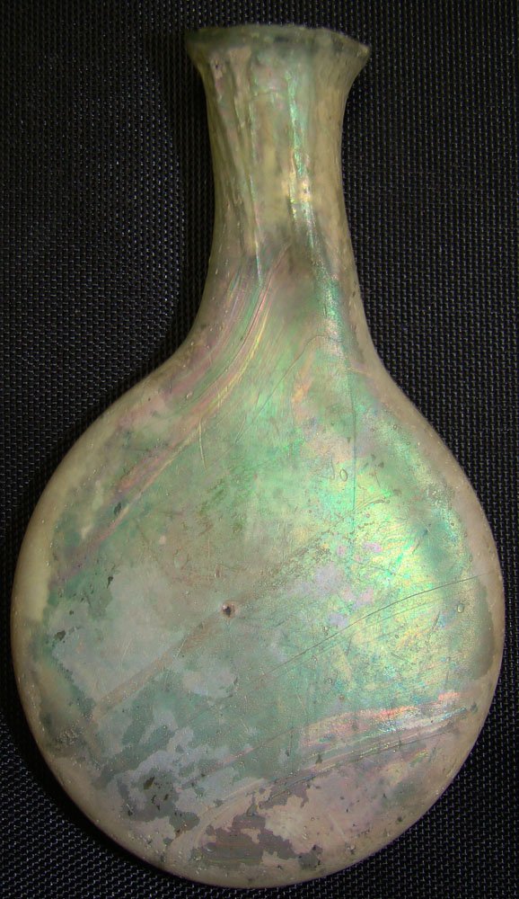 Roman, a miniature glass "pilgrim's" flask : Roman, c. 100-300AD, a miniature "pilgrim's flask with flattened body and in pale milky white and green color. H: 2.75". Slight chipping to top, otherwise very nice. Southern California Coll.