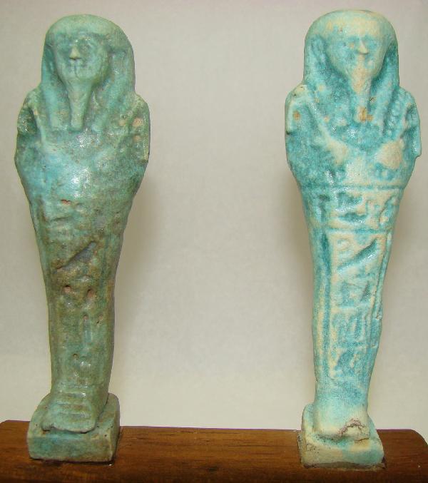 Egypt, Late Period, pair of very nice ushabtis: Egypt, Late Period, 20th-30th Dynasties, 715-332BC., a pale blue and pale blue-green smaller faience ushabti. Both with incised hieroglyphics from waist downwards. Both are mounted on wood stand. H: 4