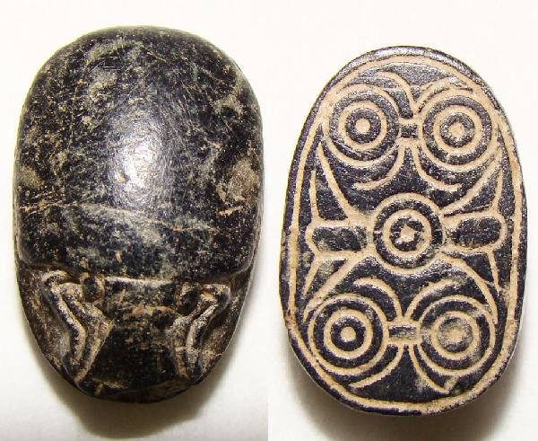 Egypt, New Kingdom, brown colored steatite scarab: Egyptian Hematite Scarab, 13th - 15th Dynasties, c. 1790 –1540 BC.Hematite (black stone) scarab, 13 x 20 mm. It is holed for hanging on a necklace or ring and the hole is open. Finely detailed obver