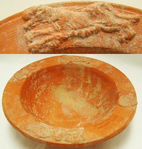 Roman Africa, c. 100-300AD., a nice red ware bowl: Roman Africa, c. 100-300AD., a very nice and decorative red ware bowl with four applied designs that adorn one inch flattened lip of bowl. Two leaves are across from each other as our tow leaping lion