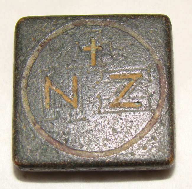 Byzantine, c. 750-900AD small square bronze weight: Byzantine, c. 750-900AD., a small square bronze weight. On obverse within incised circle is a small cross, NZ below . Weight is 26.2 grams, measures 7/8" square. Choice. Paul Bessey Collection.