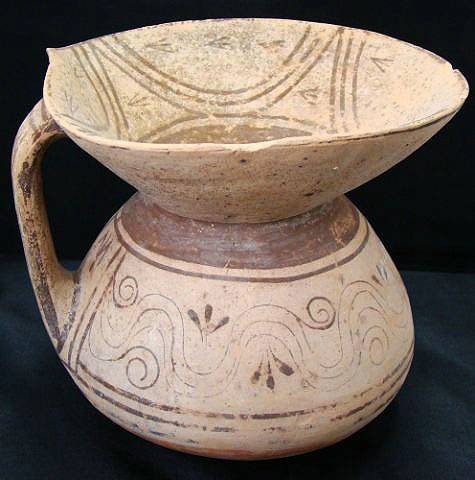 Daunian, terra cotta pot with large wide spout: Daunian, 350-325 BC., a semi round crème colored terra cotta pot with single handle and extremely large wide flared spout. Thin horizontal linear bands in brown and grey paint encircle the body of th