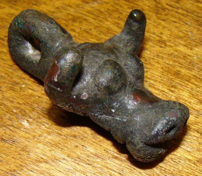 Greco-Roman. c. 100BC-100AD., a bronze bucranium: Greco-Roman. c. 100BC-100AD., a bronze bucranium pendant, looped for hanging. L:37 mm. Joel L. Malter Collection, Register of Art 1587. This piece is not an ancient weight although very similar to tho