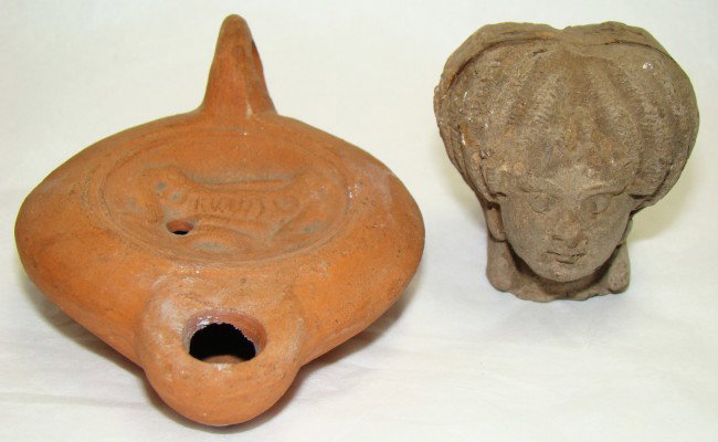 Roman, a lot of 2 interesting oil lamps: Roman, c. 1st-3rd century AD., a lot of 2 interesting pieces. First is a red slip discus shaped oil lamp with (according to Arte Primitivo) a "banquet bed" in relief inside of medallion. Old Museum nu