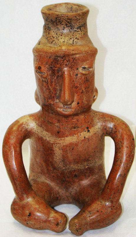 West Mexico, Colima, a fine ceramic seated male: West Mexico, Colima, c. 250BC-250AD., a fine ceramic seated male figure with his hands resting on his bent knees. Eyes and mouth are represented as horizontal slits; crème colored bands adorn his che