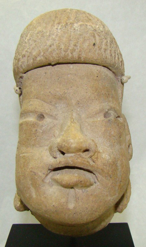 Mexico, Olmec, brown slip head fragment: Mexico, Olmec, c. 1500-500BC., a highly detailed small and choice pale brown slip head fragment. Characteristic Olmec face with parted lips, open mouth, and protruding lips. Some restoration. Mounted 