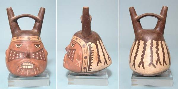 Attractive Portrait Head Vessel of a Nazca Warrior: Peru, Nazca, c. AD 200 - 500. An attractive portrait head vessel of a Nazca warrior. Small and finely crafted, with a double spouted single stirrup handle and wonderfully painted face. Warrior wears f