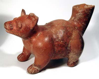 Western xico, Colima, c. 200 BC - 200 AD. A choice: Western xico, Colima, c. 200 BC - 200 AD. A choice burnished red terracotta figure of a standing dog with his hollow tail standing upright, serving as a spout; his jaws are slightly open revealing his