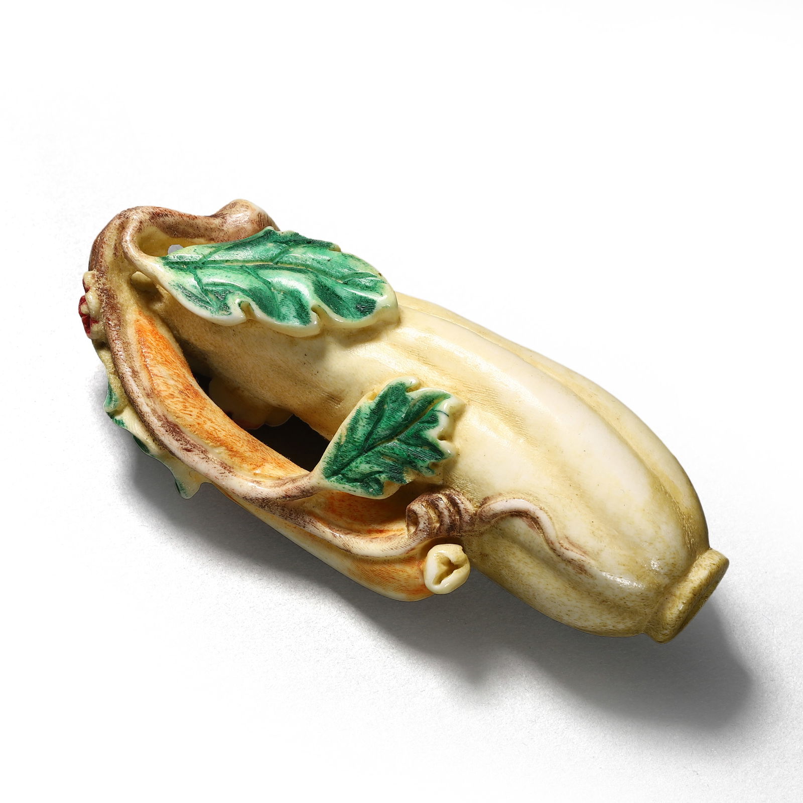 A JAPANESE DYED BONE CARVING OF A GOURD: Dimensions: Length: 3 3/8 in. (8.5 cm)