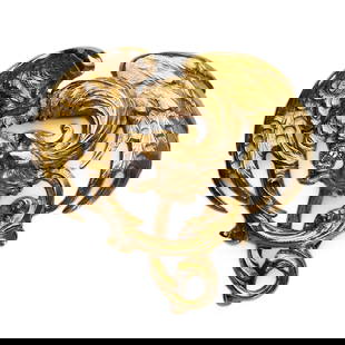 GOLD GRIFFIN BROOCH WITH DIAMOND: Dimensions Length: 1 7/16 in. (35.9 mm), Width: 1 5/16 in. (33.6 mm), Weight: 9.3 g Description This exquisitely detailed brooch features a fierce griffin rendered in gold, with outstretched wings and