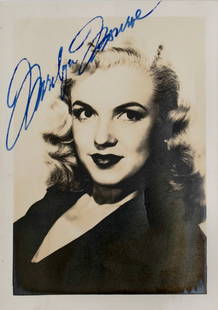 MARILYN MONROE SIGNED PHOTOGRAPH: 3 1/4 x 2 1/4 in (8 x 5.8 cm) This photograph showcases an iconic portrait of Marilyn Monroe and features her autograph. Monroe is one of the most famous film actresses of the 20th century, known not