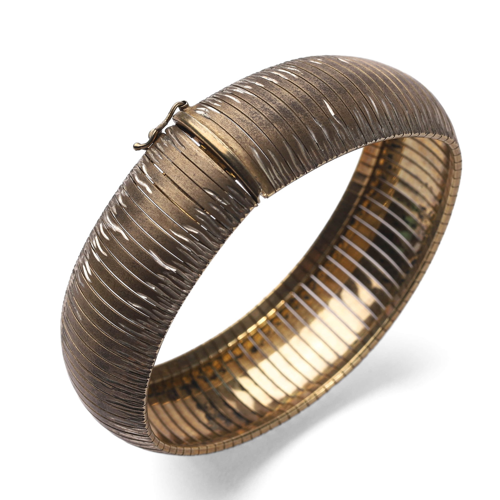 AN ITALIAN GILT SILVER FLEX BRACELET, MARKED 925: The bracelet is crafted from 925 sterling silver, with a spring-like flex construction and uniform ridged texture, finished with a warm gold wash. The interior is marked “925 ITALY” along with