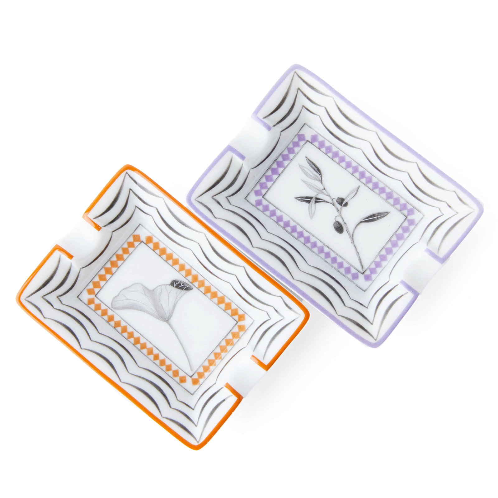 A PAIR OF HERMÈS MINIATURE PORCELAIN ASHTRAYS WITH BOTANICAL MOTIFS.: Dimensions Each 3 1/8 × 2 3/8 in (8 × 6 cm) Description A set of two rectangular Hermès miniature porcelain ashtrays, each decorated with stylized botanical motifs in monochrome, framed by geometri