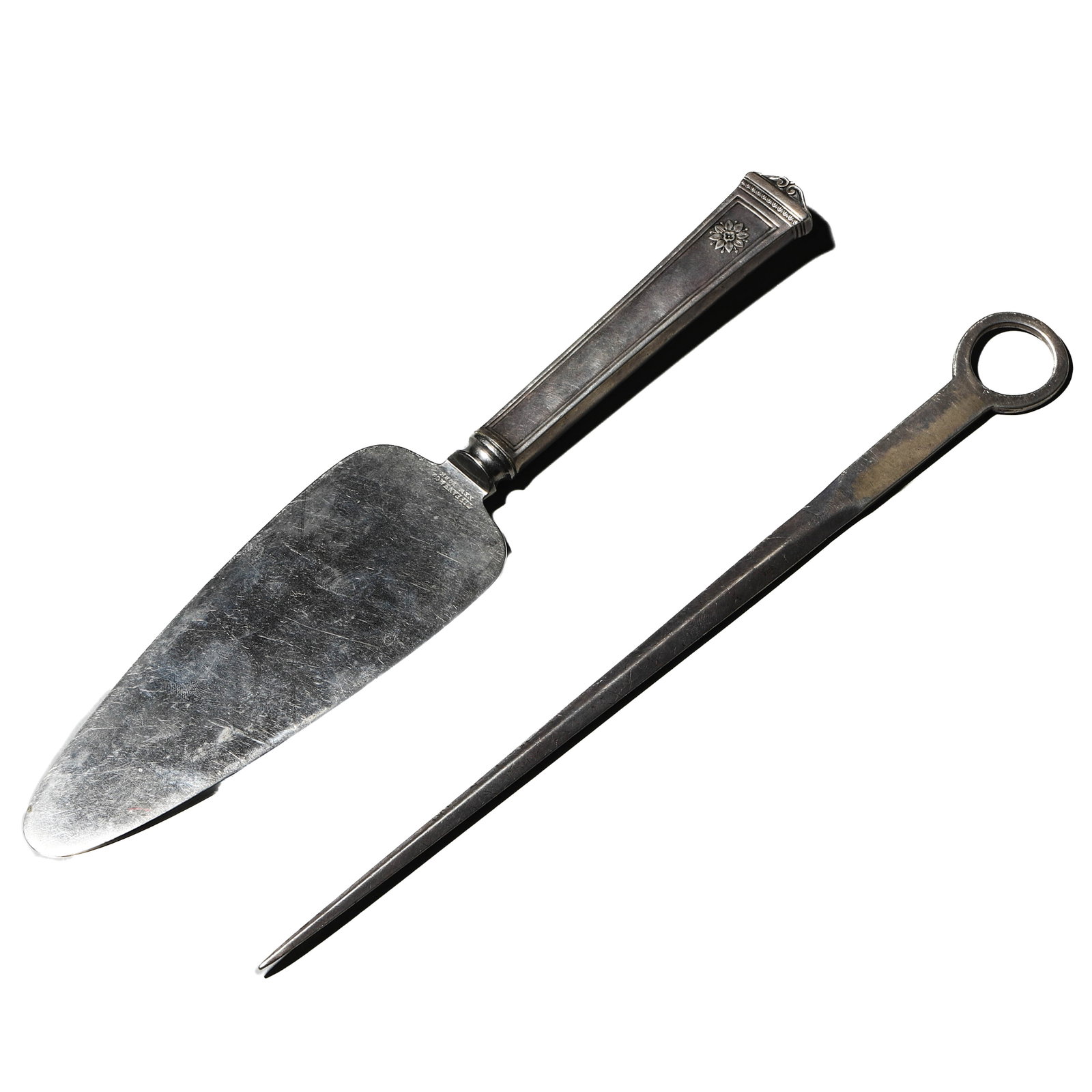 A PAIR OF ENGLISH SILVER SERVING IMPLEMENTS, 20TH CENTURY: Dimensions Cake server 10 1/4 in. (26 cm) long; Meat skewer 10 1/4 × 2 1/8 in. (26 × 5.5 cm); Total weight 170.7 g Description Comprising a silver cake server with a rectangular handle decorated wit