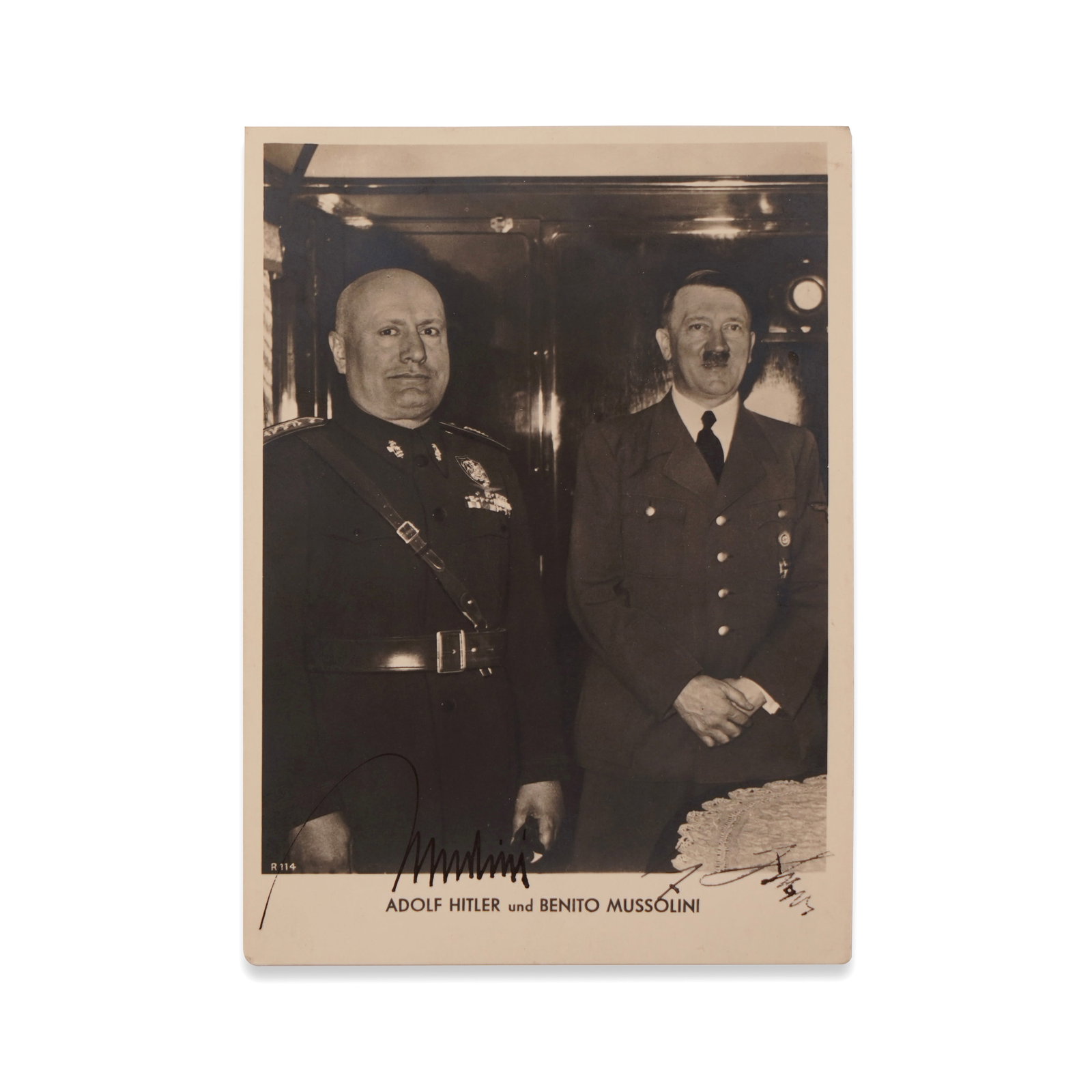 ADOLF HITLER AND BENITO MUSSOLINI SIGNED HISTORICAL POSTCARD: 5 7/8 x 4 1/8 in (15 x 10.5 cm) Provenance and Authentication: This collectible has undergone a rigorous forensic evaluation. The signatures were carefully analyzed across multiple criteria, including