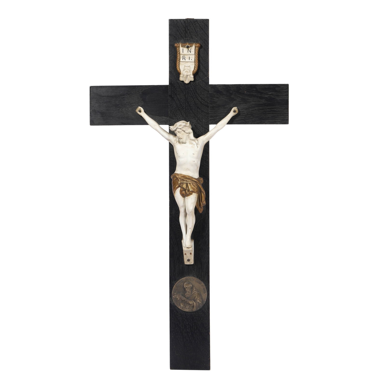 GERMAN SCHOOL, MID-20TH CENTURY — CRUCIFIX WITH SAINT KONRAD MEDALLION.: GERMAN SCHOOL, MID-20TH CENTURY — CRUCIFIX WITH SAINT KONRAD MEDALLION. Medium: Wood and ceramic with applied bronze medallion. Dimensions: Height: 23 5/8 in. (60 cm); Width: 9 1/2 in. (24 cm). Desc