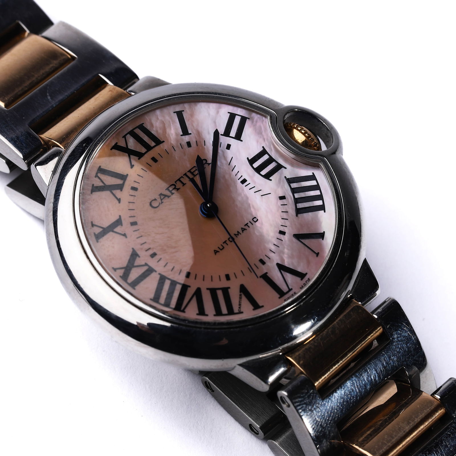 CARTIER BALLON BLEU AUTOMATIC WRISTWATCH: Dimensions Dial diameter 38.4 mm Description A Cartier Ballon Bleu automatic wristwatch in stainless steel and gold, featuring a striking pink mother-of-pearl dial with bold black Roman numerals and