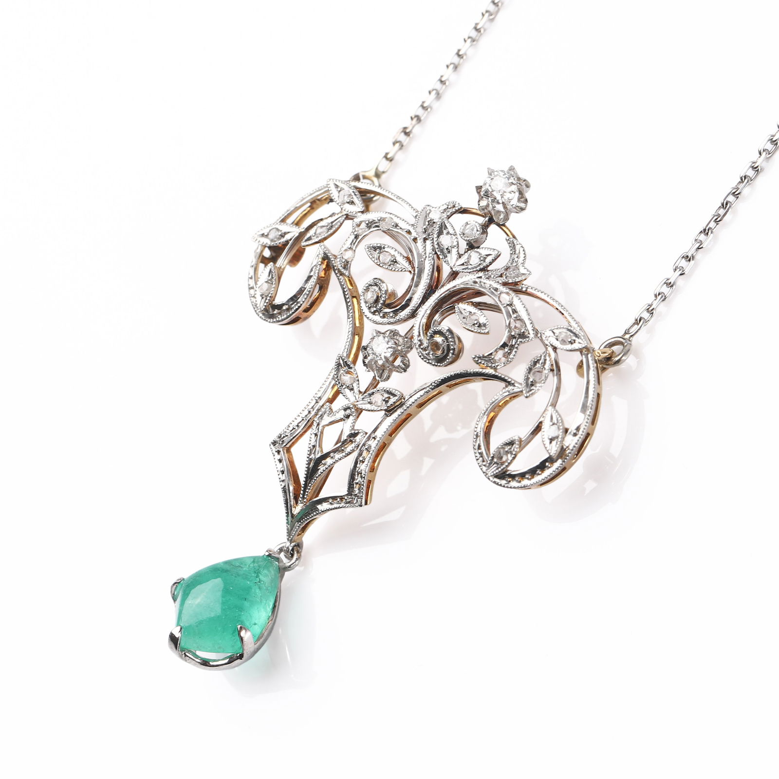 AN ART NOUVEAU GOLD, DIAMOND AND EMERALD NECKLACE: Dimensions Total length 9 1/2 in (24 cm); pendant set with a pear-shaped emerald measuring approx. 1/2 × 3/8 in (12 × 9 mm); weight 10 g. Description The necklace is designed in openwork Art